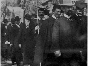 Graduates passing Hendrie Hall, Elm Street, during Yale's bicentennial celebration.